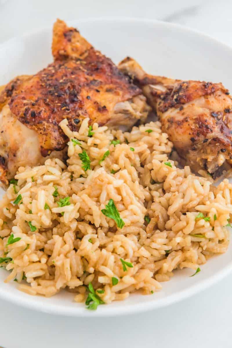 Copycat Texas Roadhouse seasoned rice and chicken on a plate.