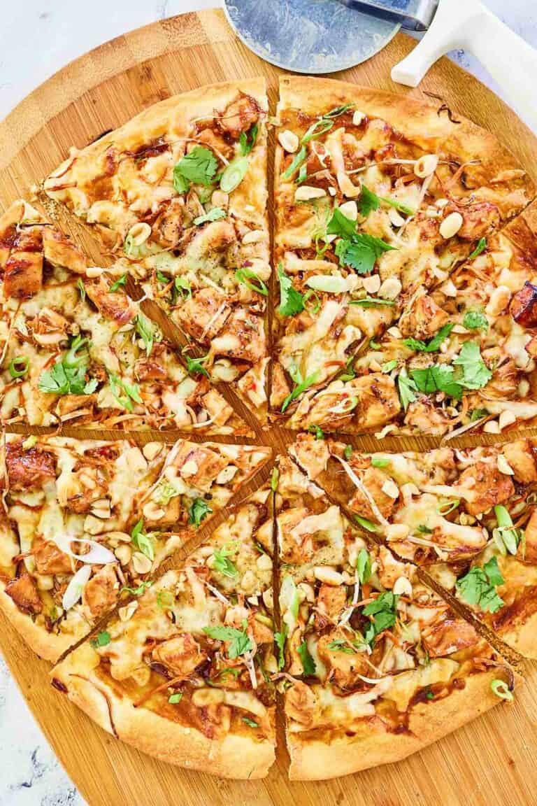 Overhead view of copycat California Pizza Kitchen Thai chicken pizza on a pizza peel.