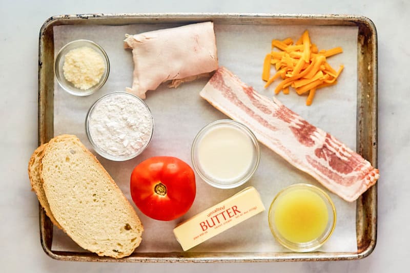 Turkey Devonshire sandwich ingredients on a tray.