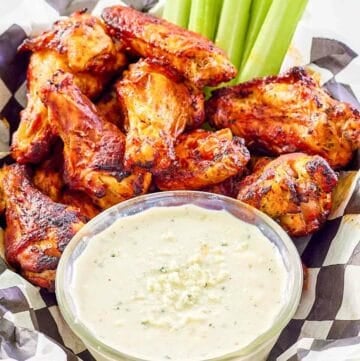 Copycat Wingstop blue cheese dip, chicken wings, and celery sticks.