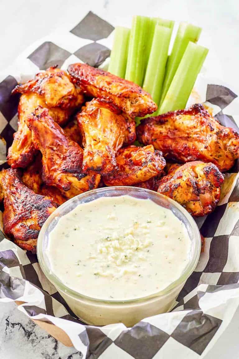 Copycat Wingstop blue cheese dip, chicken wings, and celery sticks.