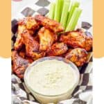 Homemade Wingstop blue cheese dip in a small bowl, chicken wings, and celery.