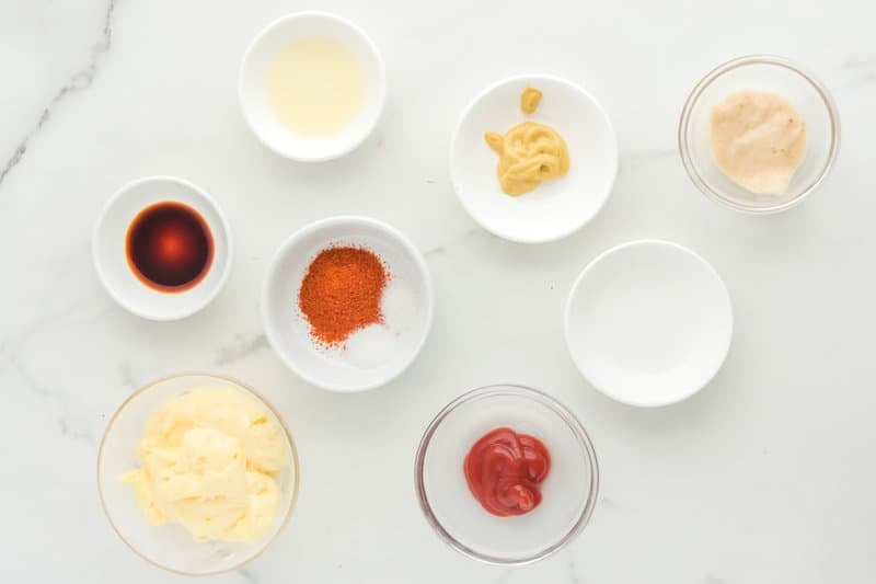 Copycat Burger King zesty condiment  ingredients connected  a marble surface.