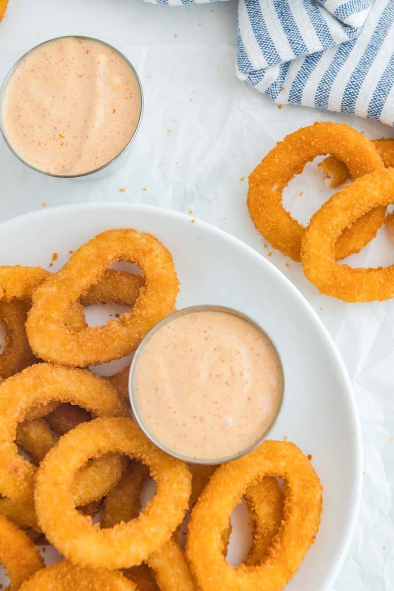 Overhead view of copycat Burger King Zesty sauce and onions rings.