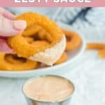 Onion ring dipped in copycat Burger King zesty sauce.