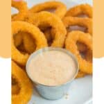 Homemade Burger King zesty sauce in a small bowl on a plate with onion rings.