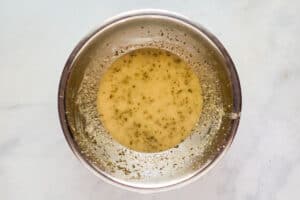 Herb vinaigrette dressing in a mixing bowl.