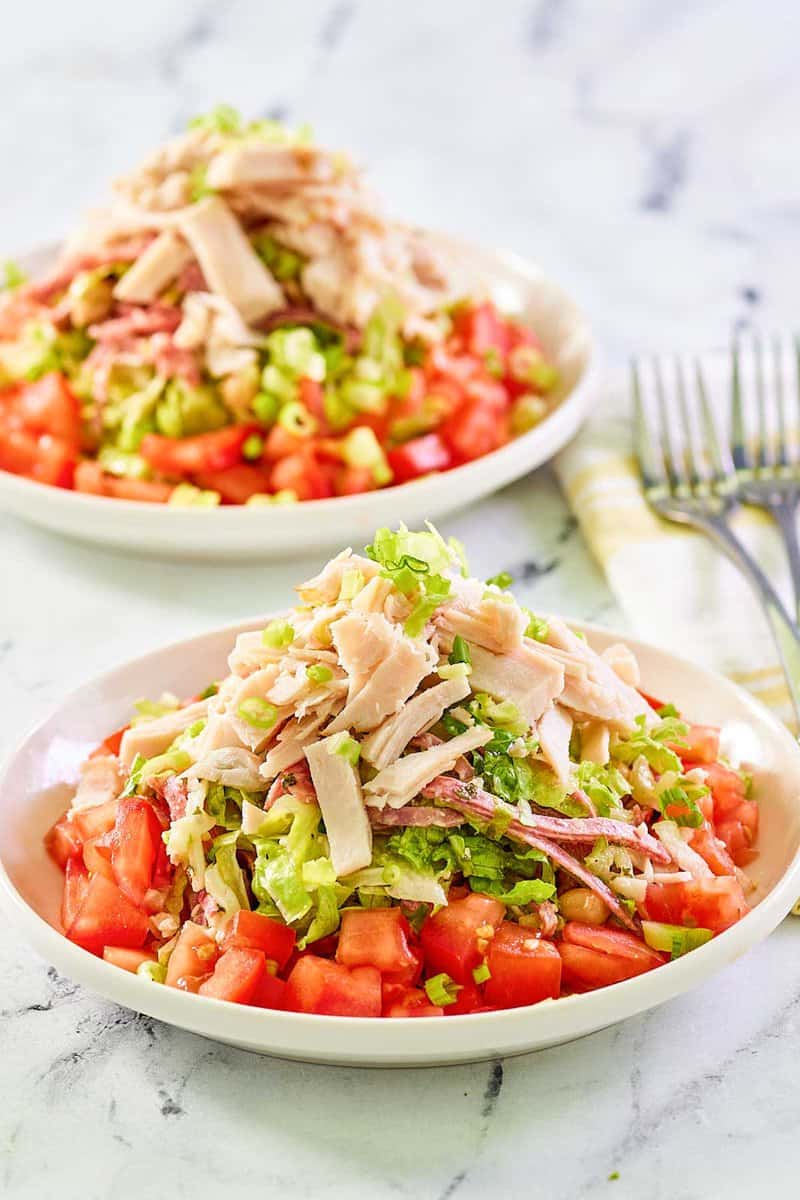 Copycat California Pizza Kitchen Italian chopped salad in two bowls.