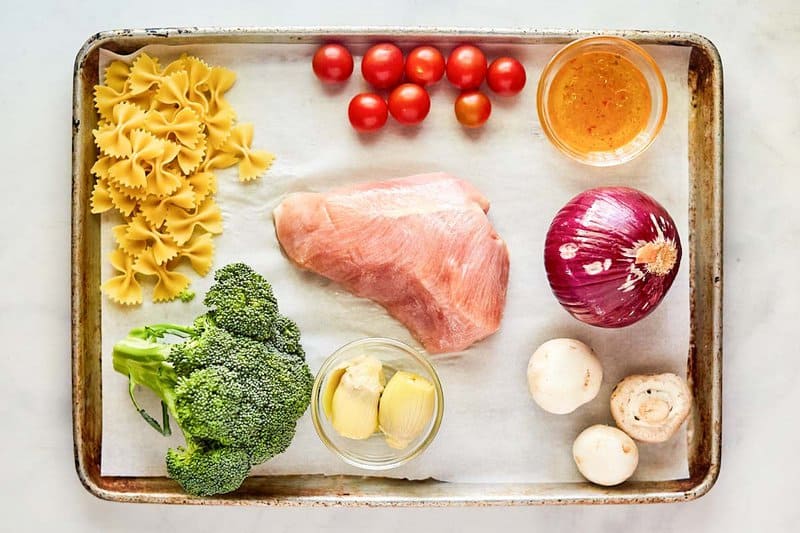 Chicken pasta salad ingredients on a tray.