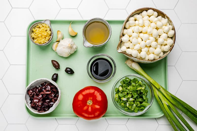 Marinated mozzarella balls ingredients connected  a tray.