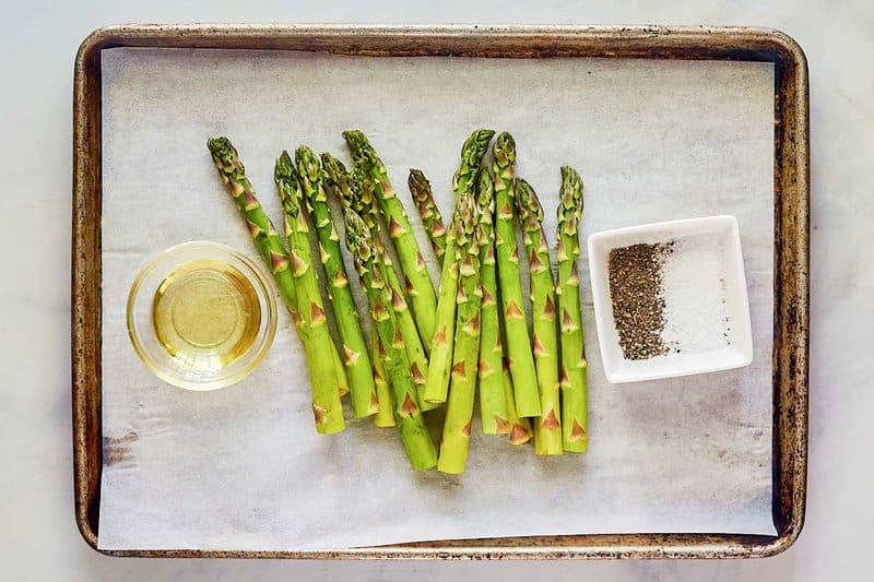 Oven roasted asparagus ingredients on a tray.