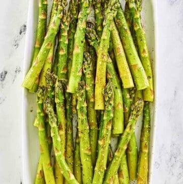 Overhead view of oven roasted asparagus on a platter.