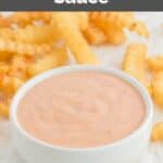 Homemade Raising Cane's sauce in a bowl and crinkle-cut fries behind it.