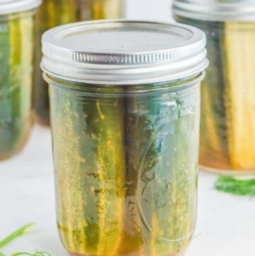 Homemade spicy dill pickles in mason jars.