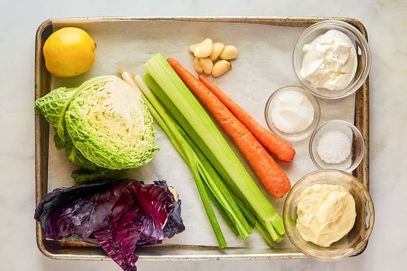 Sweet and sour coleslaw ingredients on a tray.