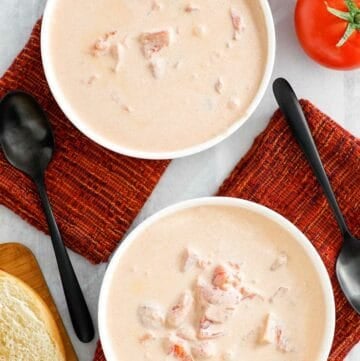 Overhead view of copycat 4B's creamy tomato soup in two bowls.