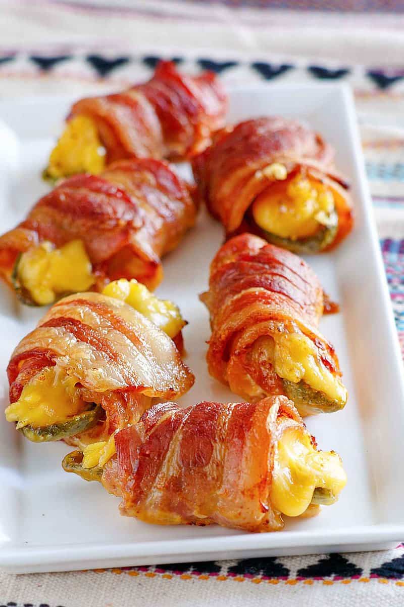 Air fryer bacon wrapped jalapeno poppers on a platter.