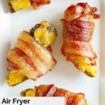Overhead view of air fryer bacon wrapped cheese stuffed jalapeno peppers.