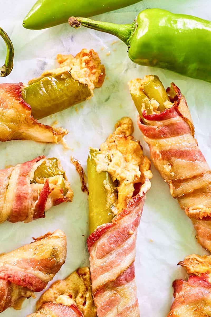 Closeup of bacon wrapped cheese stuffed hatch green chile peppers.