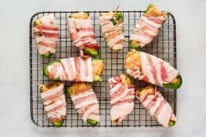 Bacon wrapped buffalo chicken poppers before cooking.