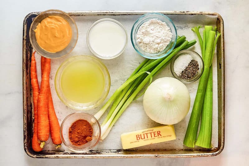 Cheddar cheese soup ingredients on a tray.