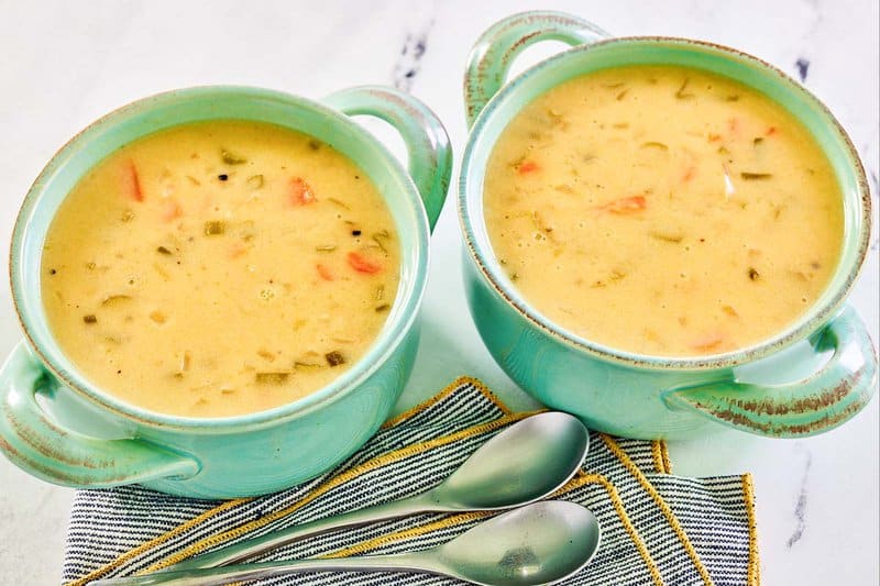 Two servings of homemade cheddar cheese soup.