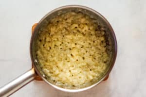 Vegetables in a flour roux in a saucepan.