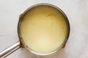 Milk and chicken broth in a saucepan.