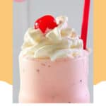 Copycat Chick Fil A peppermint milkshake topped with whipped cream and a cherry.
