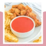 A bowl of copycat Chick Fil A Polynesian sauce on a plate with chicken nuggets and waffle fries.