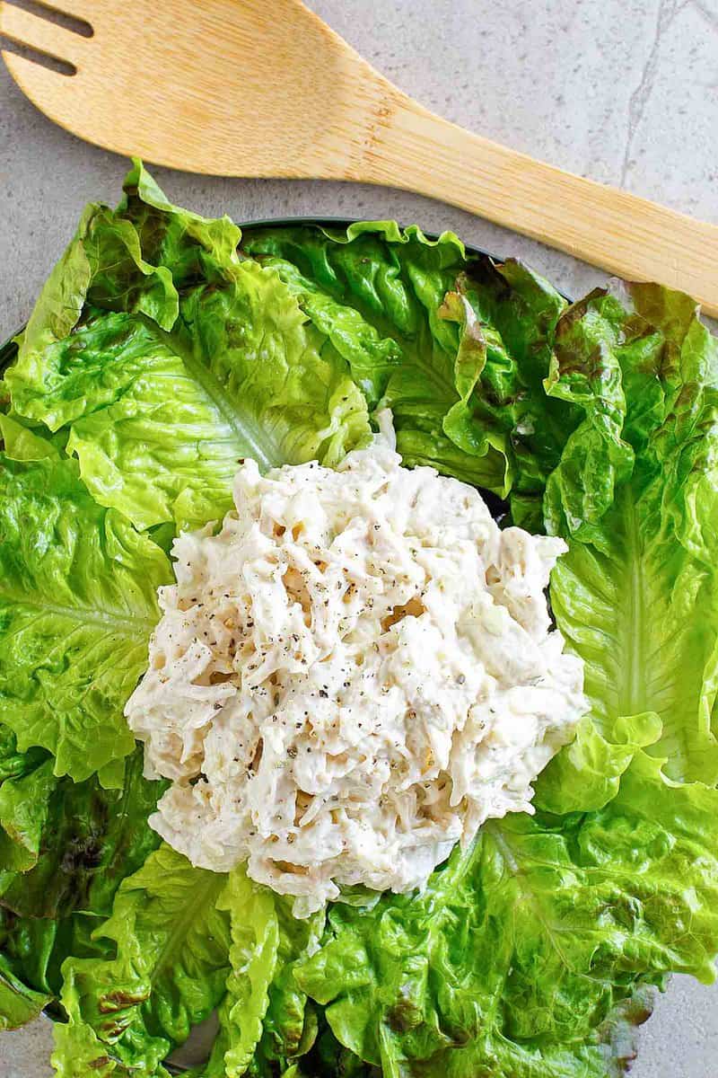 Overhead view of copycat Chicken Salad Chick Classic Carol chicken salad on top of lettuce leaves.