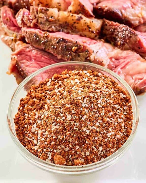 Homemade coffee rub and steak on a platter.