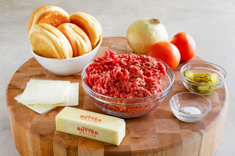 Copycat Culver's butter burger ingredients on a round wood cutting board.