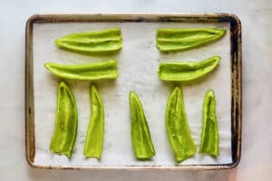 Hatch green chile peppers cut in half on a tray.