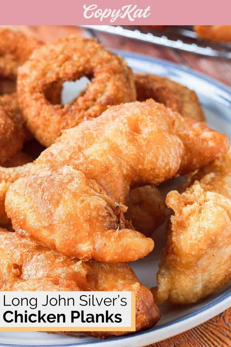 Closeup of homemade Long John Silver's chicken planks and onion rings on a blue plate.