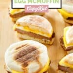 Several homemade McDonald's sausage egg mcmuffins on a wood serving board.