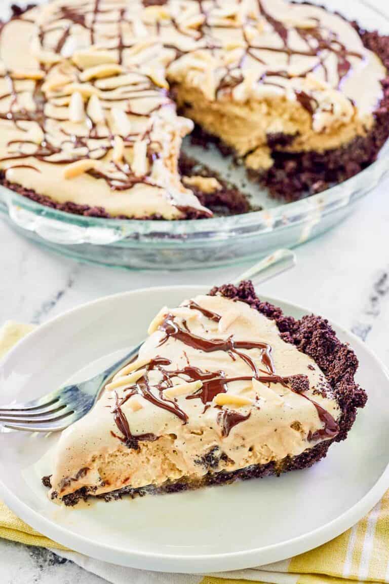 Ice cream mud pie with Oreo crust in a pie dish and a slice on a plate.