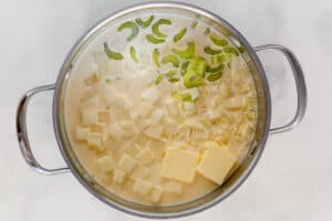 Cooking old-fashioned potato soup in a large pot.