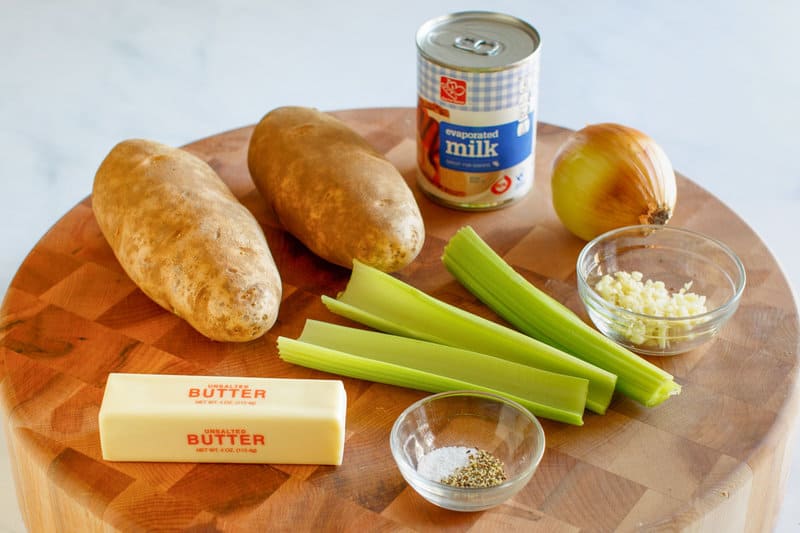 Grandma's old-fashioned potato soup ingredients on a wood board.