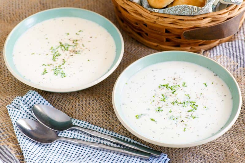 Grandma's old-fashioned potato soup in two bowls and two spoons.