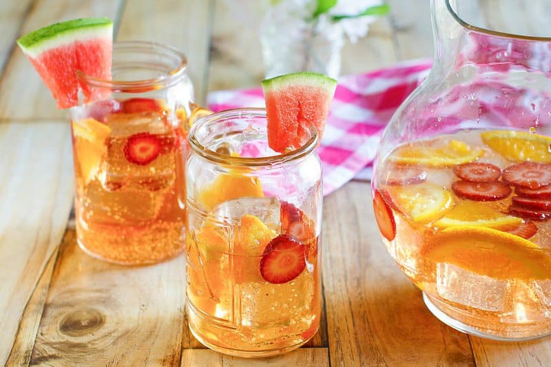 Copycat Olive Garden watermelon sangria in glasses and a pitcher.