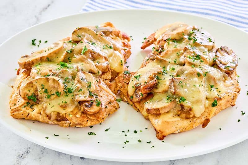 Copycat Texas Roadhouse smothered chicken on a plate.