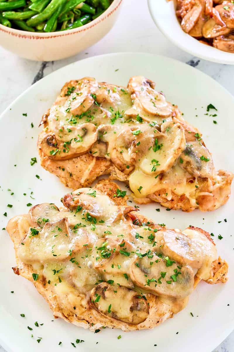 Copycat Texas Roadhouse smothered chicken on a plate.