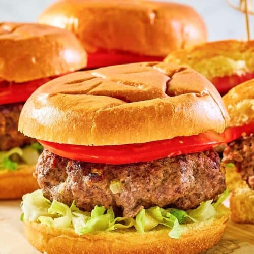 Copycat 21 Club burger on a wood board.