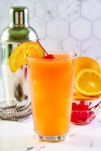 Copycat Applebee's Bahama Mama drink garnished with an orange slice and cherry.