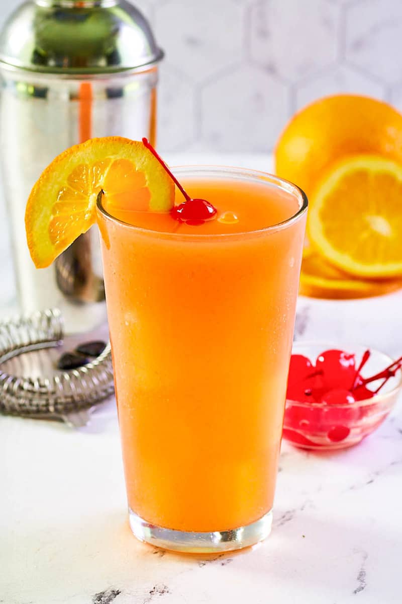 Copycat Applebee's Bahama Mama cocktail garnished with an orange slice and cherry.