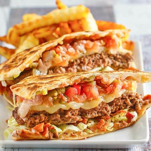 Copycat Applebee's quesadilla burger and crinkle-cut fries on a plate.