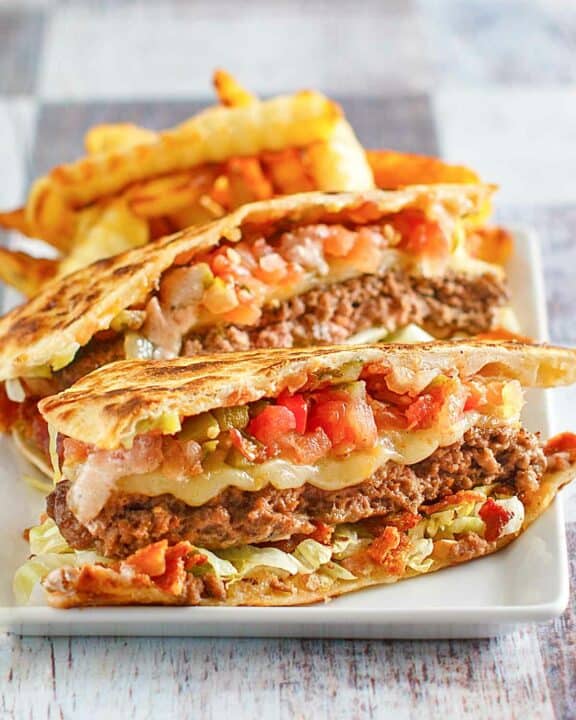 Copycat Applebee's quesadilla burger and crinkle-cut fries on a plate.