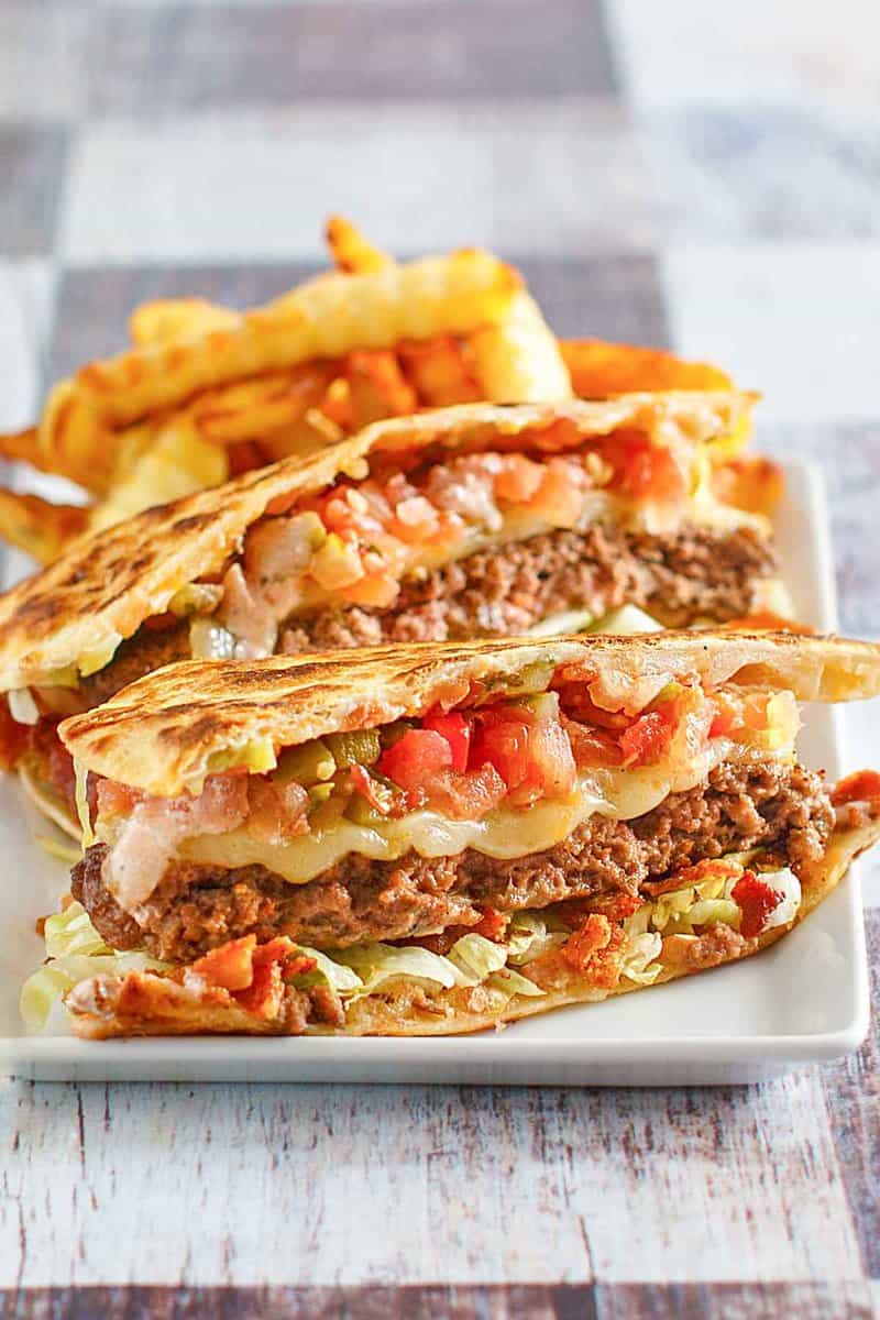 Copycat Applebee's quesadilla burger and crinkle-cut fries on a plate.