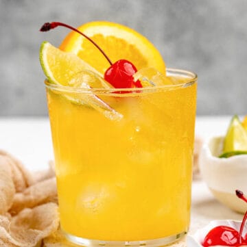 Copycat Applebee's white peach sangria garnished with orange, lime, and a cherry.